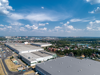 Huge warehouse building with flat roof and cars near city
