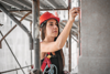 Female construction mason on the scaffoldin