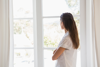 Beautiful woman looking out in the window 