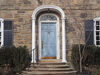 stone faced house with portico around front door